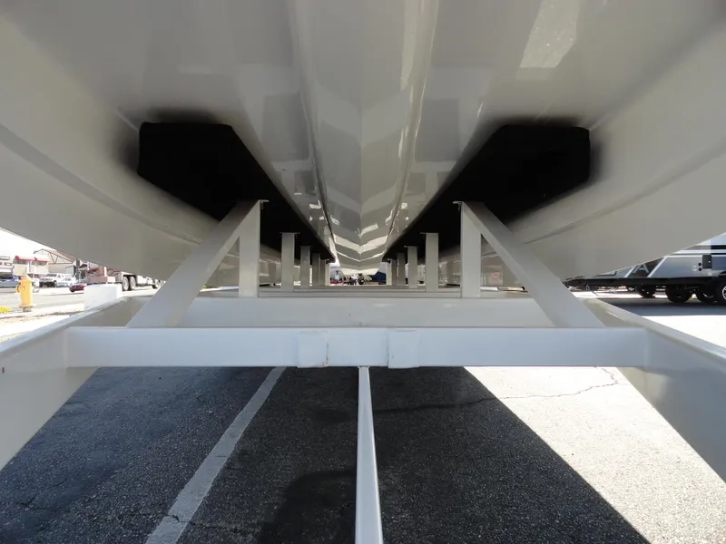 Slide: The Image of Underside view of 1996 Hallett Party Cruiser Gull Wing 300 on trailer. - 25