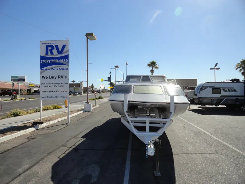 Slide: The Image of 1996 Hallett Party Cruiser Gull Wing 300 boat on trailer at RV dealership. - 3
