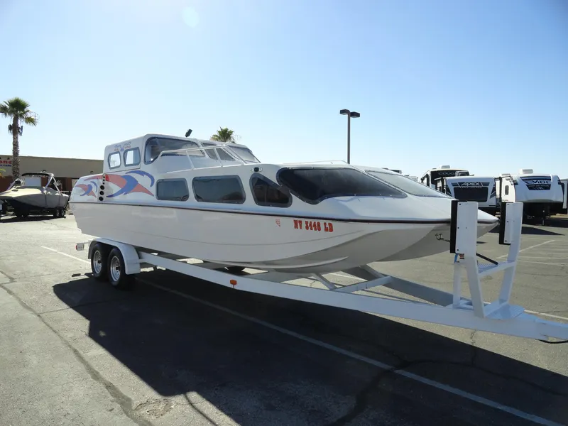 Slide: The Image of 1996 Hallett Party Cruiser Gull Wing 300 on trailer in parking lot. - 4