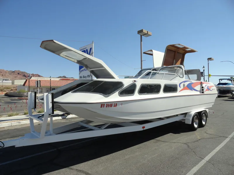 Slide: The Image of 1996 Hallett Party Cruiser Gull Wing 300 on trailer, white with colorful graphics. - 7