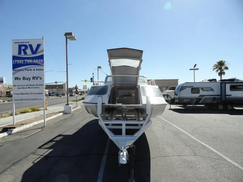 Slide: The Image of 1996 Hallett Party Cruiser Gull Wing 300 boat on trailer at RV dealership. - 8