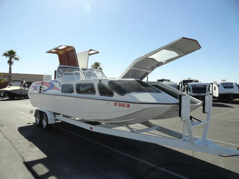 Slide: The Image of 1996 Hallett Party Cruiser Gull Wing 300 on trailer with open gull wing doors. - 9