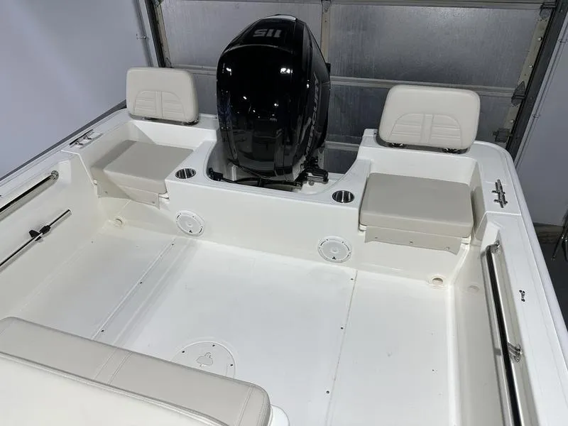 Slide: The Image of 2025 Boston Whaler 190 Montauk boat interior with seating and engine. - 10