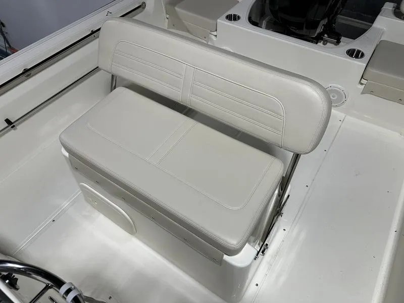 Slide: The Image of 2025 Boston Whaler 190 Montauk boat interior with white cushioned seating. - 11