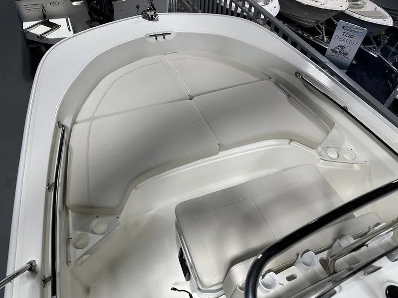 Slide: The Image of 2025 Boston Whaler 190 Montauk boat interior with cushioned seating and storage. - 16