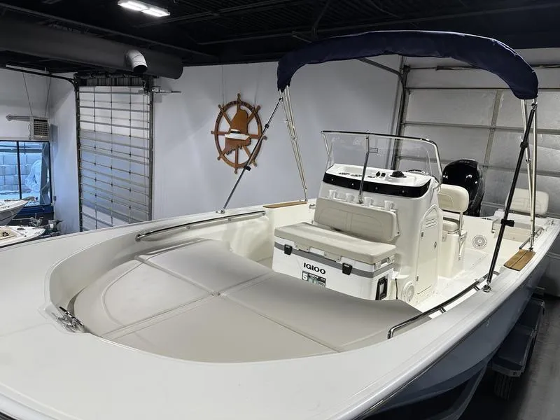 Slide: The Image of 2025 Boston Whaler 190 Montauk boat in showroom, featuring sleek design and modern amenities. - 5