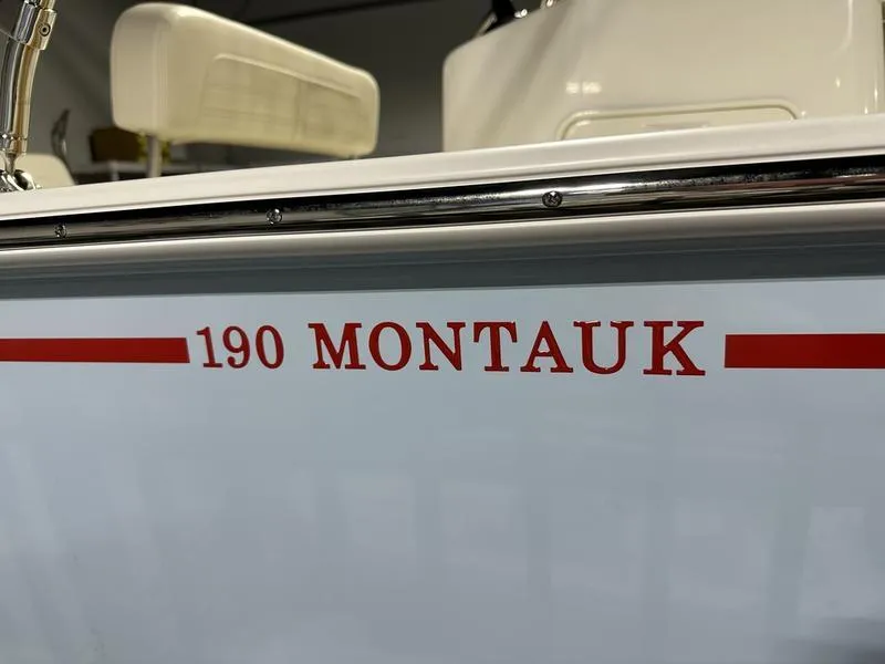Slide: The Image of 2025 Boston Whaler 190 Montauk boat side view with red lettering. - 6