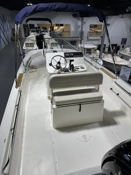 Slide: The Image of 2025 Boston Whaler 190 Montauk boat interior with steering console and seating. - 8