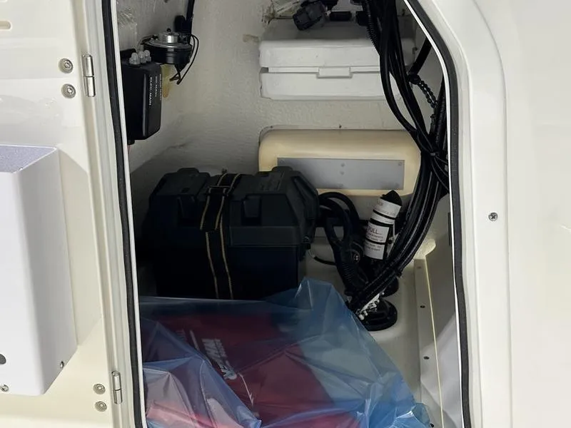 Slide: The Image of 2025 Boston Whaler 170 Montauk storage compartment with battery and wiring. - 11