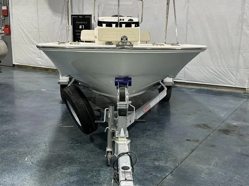 Slide: The Image of 2025 Boston Whaler 170 Montauk boat on trailer in indoor showroom. - 2