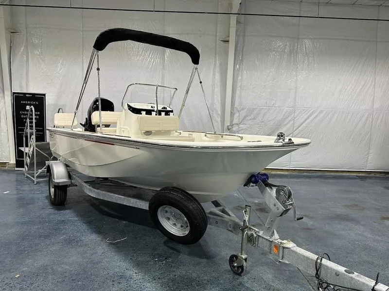 Slide: The Image of 2025 Boston Whaler 170 Montauk boat on trailer in indoor showroom. - 3