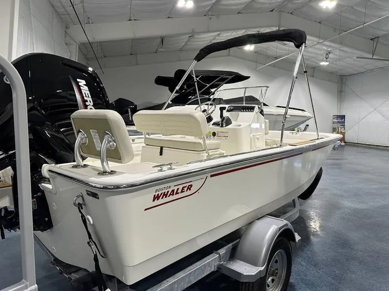 Slide: The Image of 2025 Boston Whaler 170 Montauk boat on trailer in showroom. - 4
