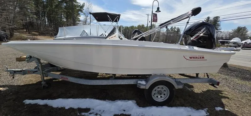 Slide: The Image of 2025 Boston Whaler 160 Super Sport boat on trailer, parked outdoors. - 2