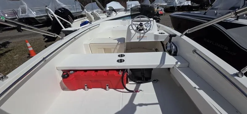 Slide: The Image of 2025 Boston Whaler 160 Super Sport boat interior with steering wheel and seating. - 5