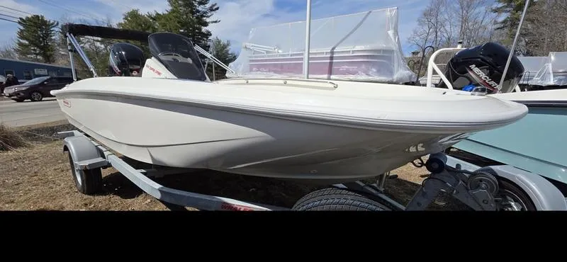 Slide: The Image of 2025 Boston Whaler 160 Super Sport boat on trailer, parked outdoors. - 8