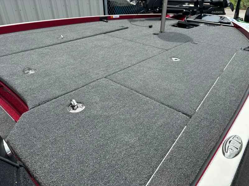 Slide: The Image of 2025 Ranger Z521R boat deck with gray carpet and storage compartments. - 6