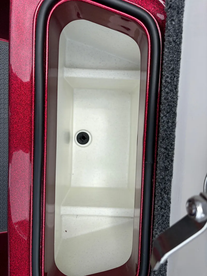 Slide: The Image of Ranger Z521R 2025 boat storage compartment with red trim. - 7