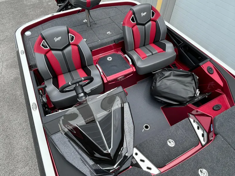 Slide: The Image of 2025 Ranger Z521R boat interior with red and black seats and steering console. - 8