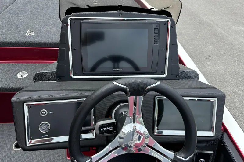 Slide: The Image of 2025 Ranger Z521R boat dashboard with steering wheel and Garmin display. - 9