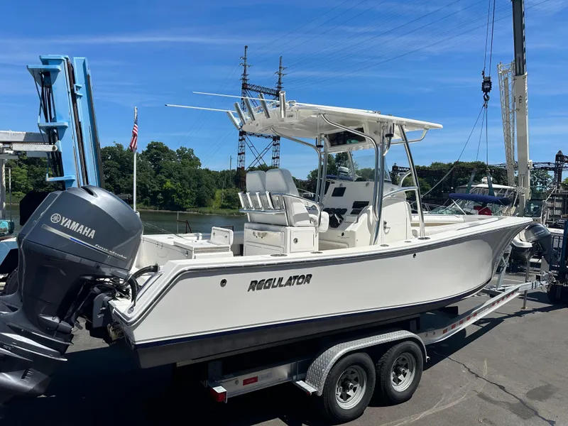Slide: The Image of 2012 Regulator 24 FS boat on trailer with Yamaha outboard motor. - 2