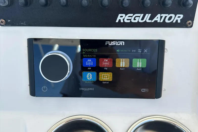 Slide: The Image of Fusion MS-RA770 marine stereo on a 2012 Regulator 24 FS boat dashboard. - 5