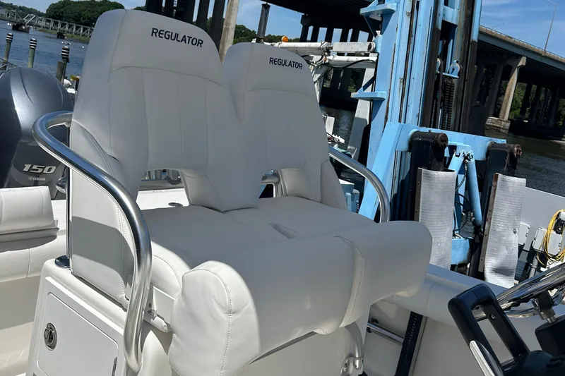 Slide: The Image of 2012 Regulator 24 FS boat with dual white cushioned seats. - 7
