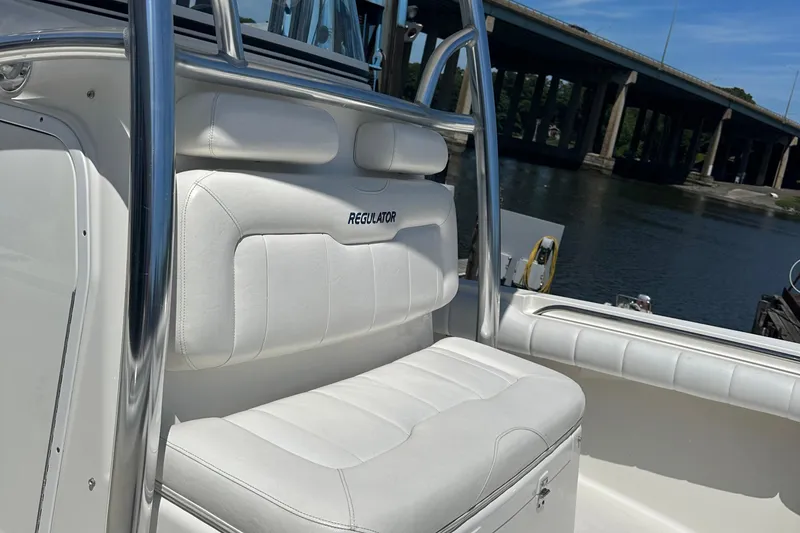Slide: The Image of 2012 Regulator 24 FS boat with white seating near a bridge. - 8