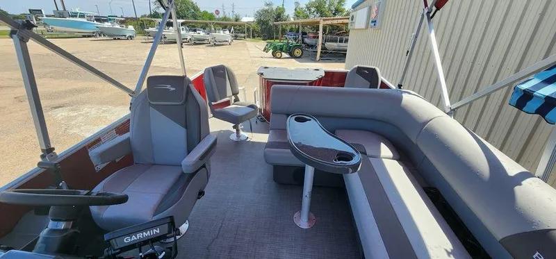 Slide: The Image of 2024 Bennington 20 SVF pontoon boat interior with seating and Garmin equipment. - 13