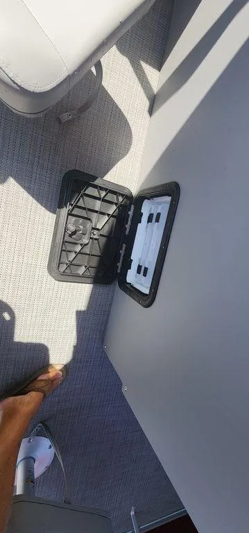 Slide: The Image of 2024 Bennington 20 SVF boat interior with open storage compartment. - 14