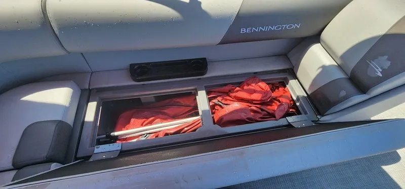 Slide: The Image of 2024 Bennington 20 SVF boat seat storage with red fabric inside. - 15
