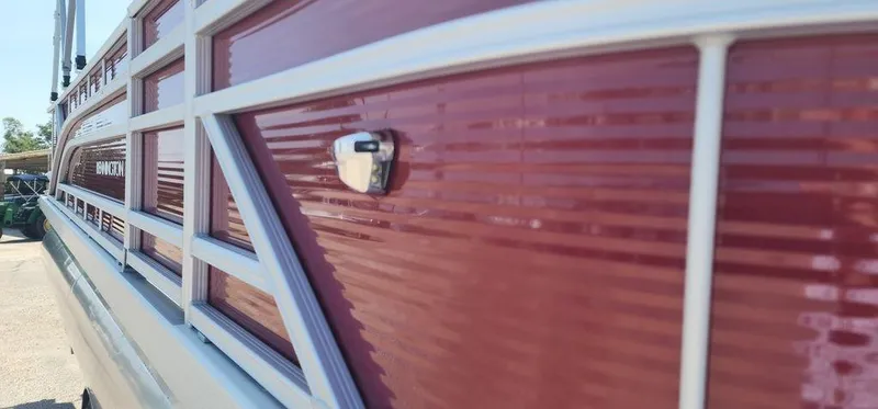 Slide: The Image of Close-up of 2024 Bennington 20 SVF pontoon boat with red and white exterior. - 3