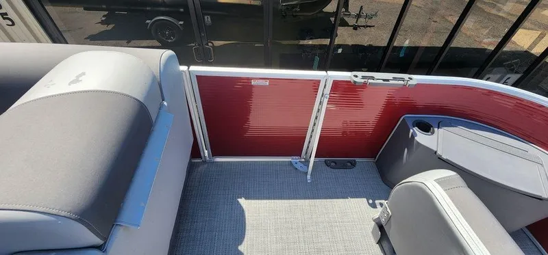 Slide: The Image of 2024 Bennington 20 SVF pontoon boat interior with red paneling and gray seating. - 31