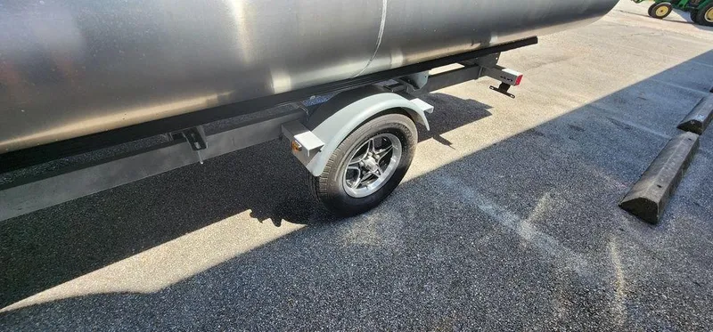 Slide: The Image of 2024 Bennington 20 SVF pontoon trailer wheel on asphalt surface. - 37