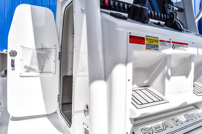 Slide: The Image of 2025 Sea Hunt Escape 25 boat interior with open door and control panel. - 9