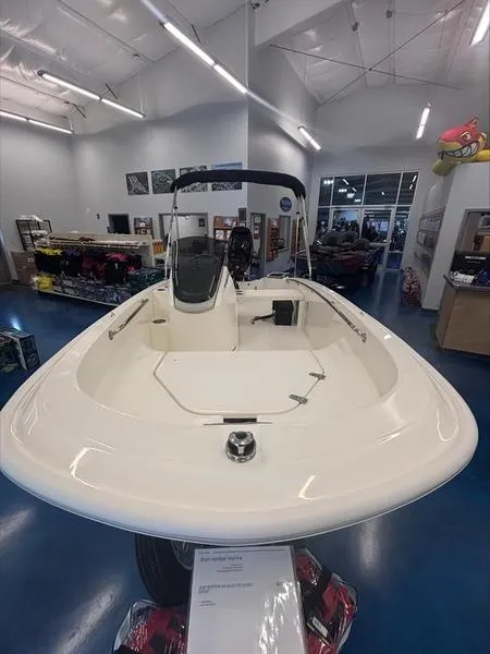 Slide: The Image of 2025 Boston Whaler 130 Super Sport boat displayed in showroom. - 10