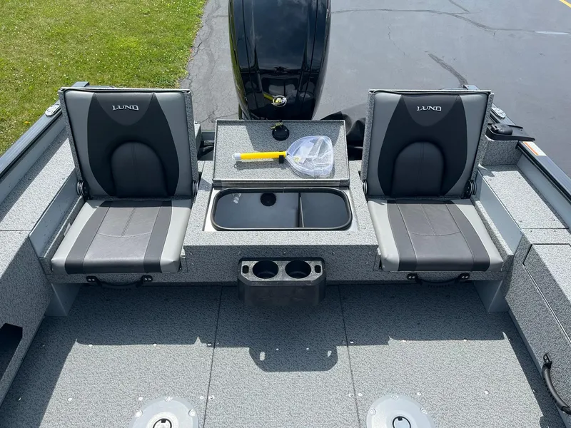 Slide: The Image of 2025 Lund 1775 Adventure SS boat interior with two seats and storage compartment. - 11