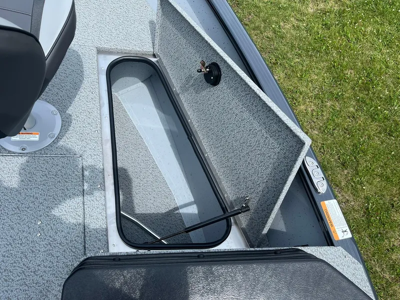Slide: The Image of 2025 Lund 1775 Adventure SS boat storage compartment open on deck. - 16