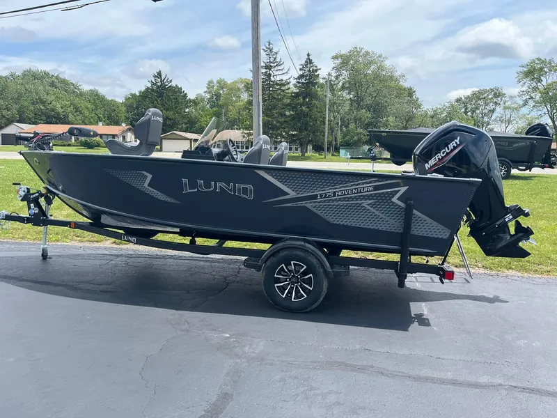 Slide: The Image of 2025 Lund 1775 Adventure SS fishing boat on trailer with Mercury outboard motor. - 3