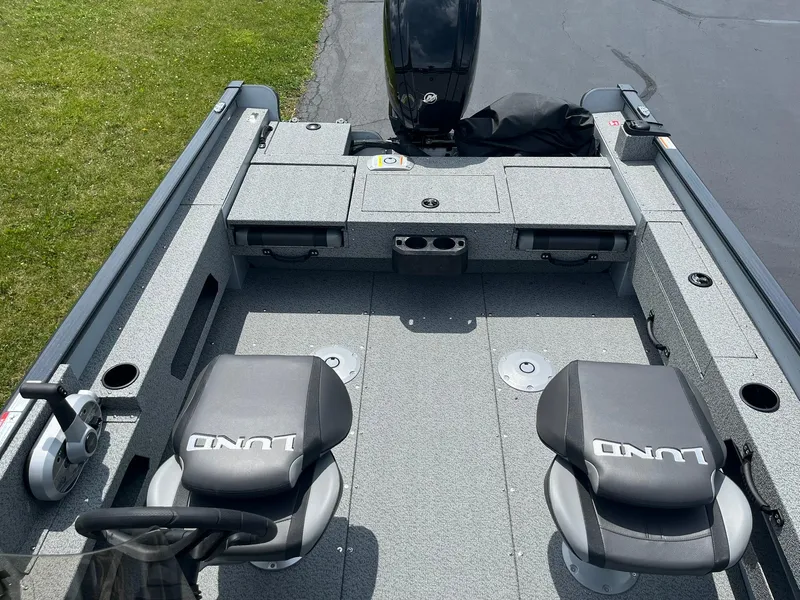 Slide: The Image of 2025 Lund 1775 Adventure SS fishing boat interior with two seats and storage compartments. - 7