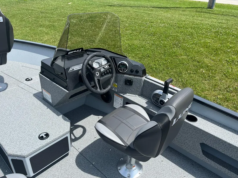 Slide: The Image of 2025 Lund 1775 Adventure SS boat interior with steering console and captain's chair. - 8