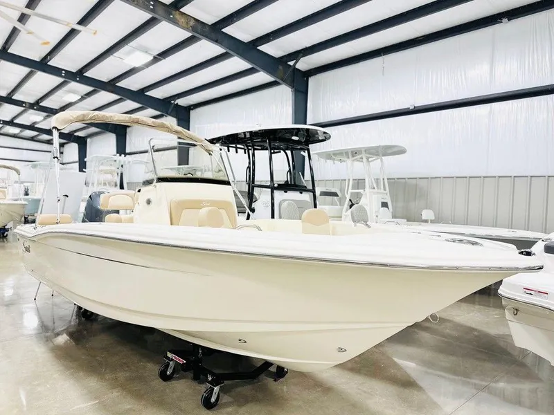 The Image of 2025 Scout 195 Sportfish boat displayed in a showroom. - 1