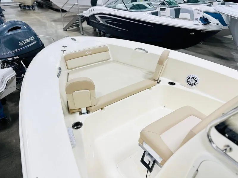 Slide: The Image of 2025 Scout 195 Sportfish boat interior with beige seating and Yamaha outboard motor. - 6