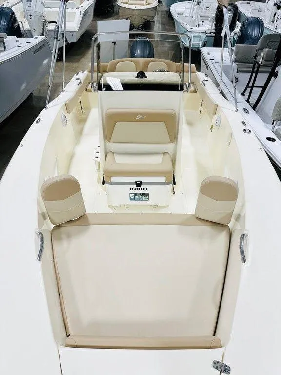 Slide: The Image of 2025 Scout 195 Sportfish boat interior with beige seating and console. - 7