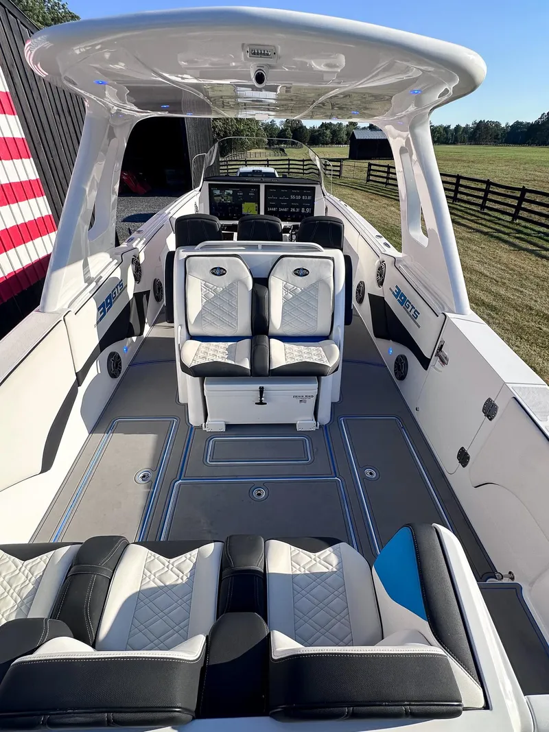 Slide: The Image of 2021 Cigarette 39 GTS boat interior with luxurious seating and advanced dashboard. - 12