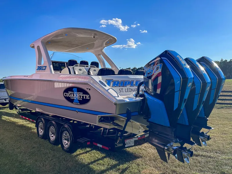 Slide: The Image of 2021 Cigarette 39 GTS boat with triple outboard engines on a trailer. - 17