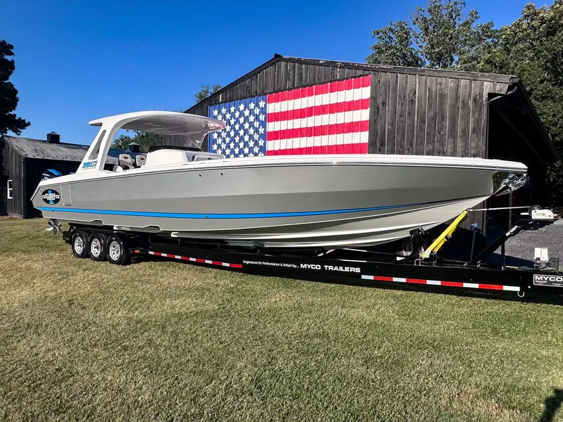 Slide: The Image of 2021 Cigarette 39 GTS boat on trailer, American flag backdrop. - 3