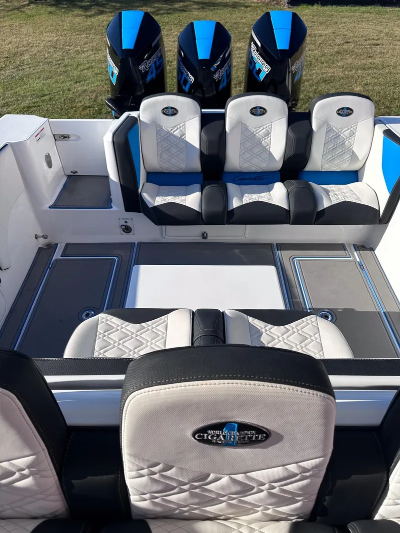 Slide: The Image of 2021 Cigarette 39 GTS boat interior with triple outboard engines and luxury seating. - 6