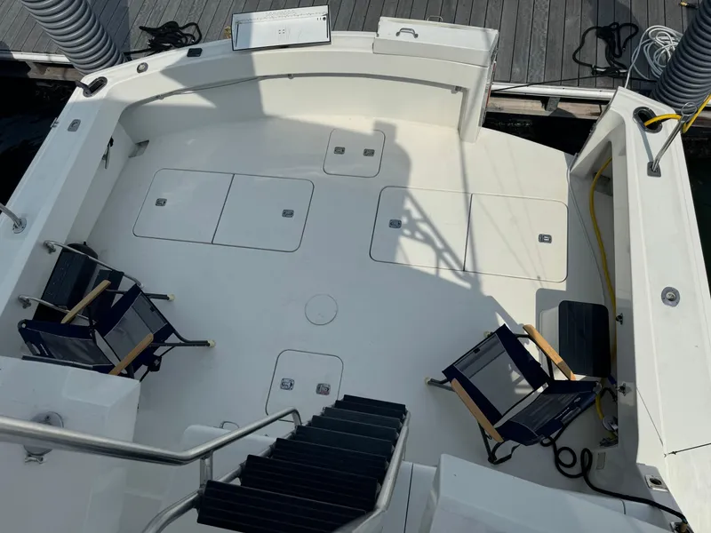 Slide: The Image of 1994 Hatteras 54 Convertible yacht deck with chairs and storage compartments. - 11