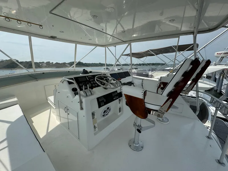 Slide: The Image of Helm of 1994 Hatteras 54 Convertible yacht with captain's chair and control panel. - 19