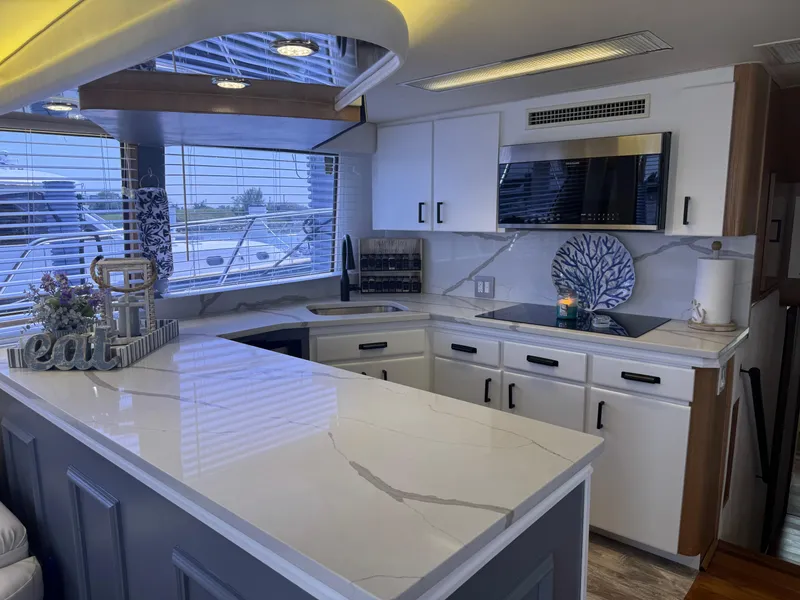 Slide: The Image of Luxurious kitchen interior of 1994 Hatteras 54 Convertible yacht with modern appliances and sleek design. - 26